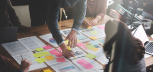 people creating a plan on paper and sticky notes