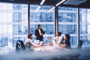 office workers having a discussion round a table