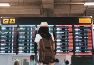 woman looking at departure board in airport