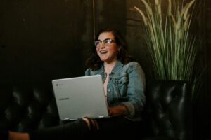 woman smiling at laptop 