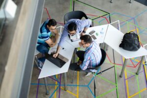 birds-eye view of men looking at a laptop