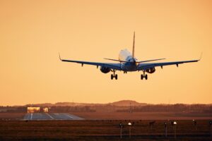 Plane landing at sunset
