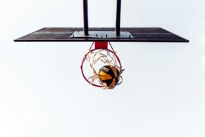 View of basketball going through net from beneath