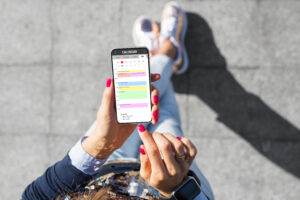 woman checking itinerary in phone calendar