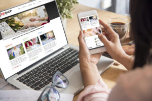 Person using website homepage on mobile and laptop