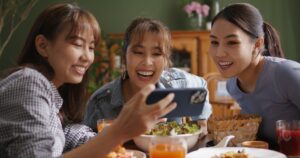 3 girls laughing at content on a phone