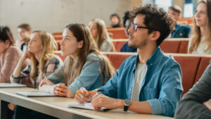 Students sat in a lecture theatre.