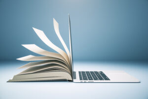 A book and a laptop back-to-back