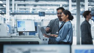man and woman engineers look at a laptop